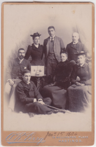 Calderon family photograph, 1 January 1894. Clockwise: seated on floor George Calderon, Jack Calderon, Marge Calderon, Fred Calderon, Alfred Merigon Calderon, Evelyn Calderon, seated next to table Clara Calderon.
